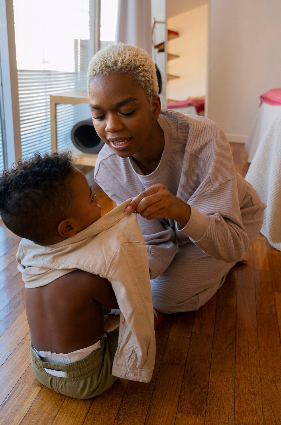 full-shot-mother-dressing-kid_23-2149748320